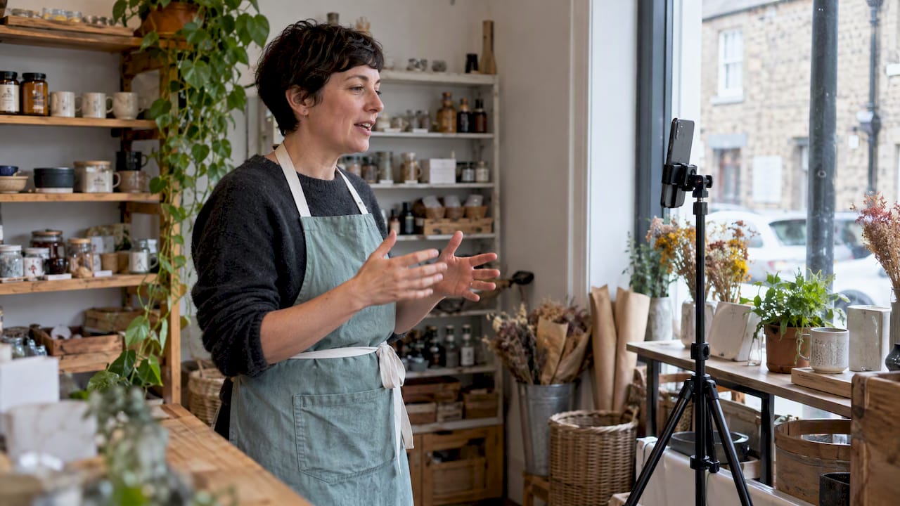 Shop owner recording a short business Reel